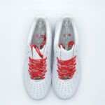 Top-down view of Supreme Air Force 1 White sneakers featuring red Supreme logo shoelaces and premium leather