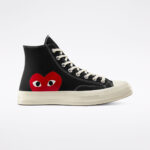 Side view of CDG Play Converse High Top Black featuring the iconic red heart logo with eyes designed by Filip Pagowski on a black canvas upper.