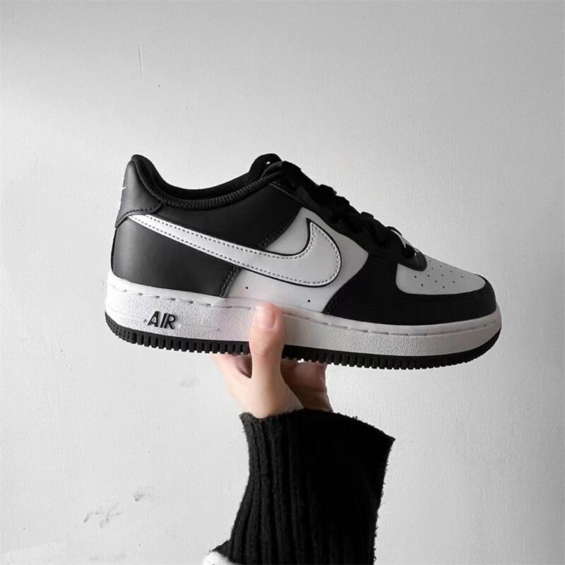 Nike Air Force 1 Low Panda DV0788-001 held in hand displaying side profile, leather materials, and black white colorway.