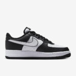 Medial side profile of Nike Air Force 1 Low Panda with black and white leather color blocking and Nike Air sole unit.