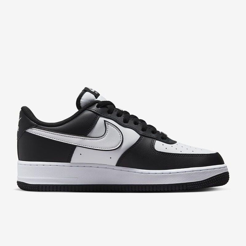 Medial side profile of Nike Air Force 1 Low Panda with black and white leather color blocking and Nike Air sole unit.