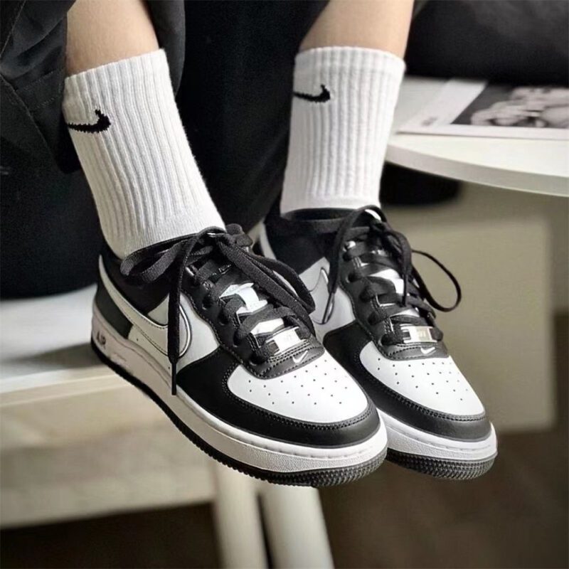Nike Air Force 1 Panda worn with black pants and white Nike socks in a casual streetwear outfit.