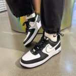 Nike Air Force 1 Panda worn with joggers and crew socks showcasing the iconic black and white sneaker design.
