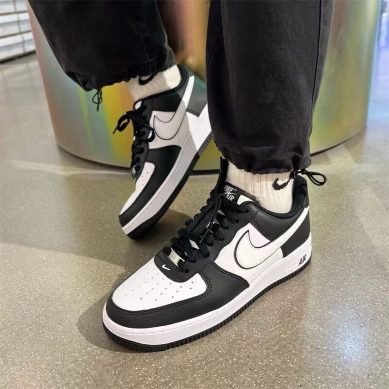 Nike Air Force 1 Panda worn with joggers and crew socks showcasing the iconic black and white sneaker design.