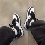 Top-down on-feet view of Nike Air Force 1 Panda showcasing black and white leather panels and AF1 silhouette.
