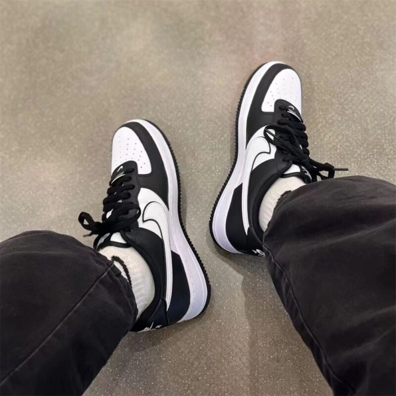 Top-down on-feet view of Nike Air Force 1 Panda showcasing black and white leather panels and AF1 silhouette.