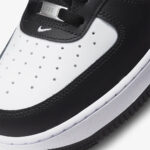 Close-up of Nike Air Force 1 Panda toe box showing perforated leather construction, AF1 lace dubrae, and premium stitching.