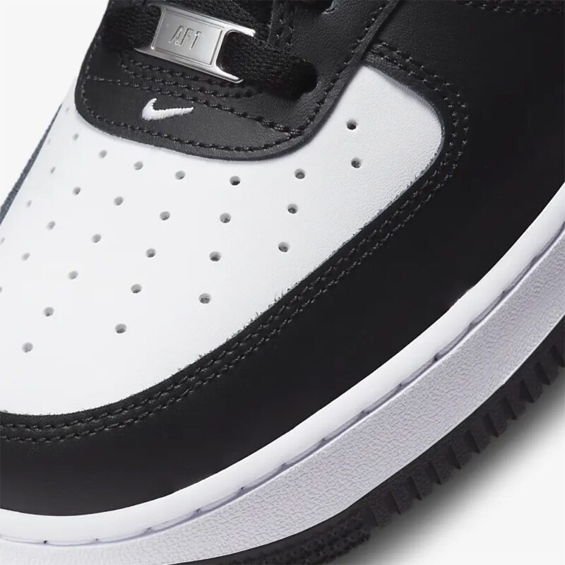 Close-up of Nike Air Force 1 Panda toe box showing perforated leather construction, AF1 lace dubrae, and premium stitching.