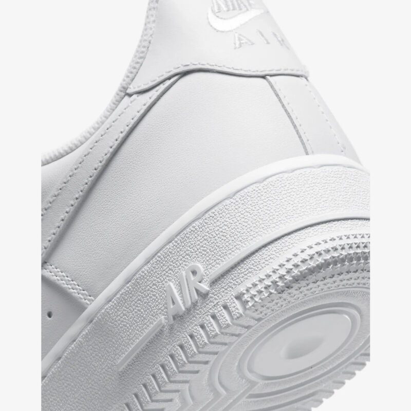 Close-up of Nike Air Force 1 Low Triple White midsole with AIR branding, textured rubber, and classic traction detail.