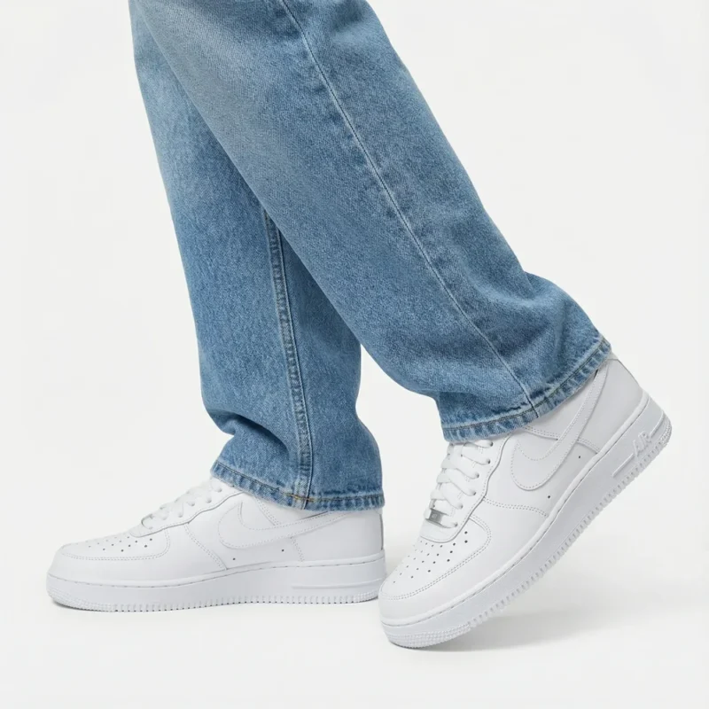 Nike Air Force 1 Low Triple White worn with blue denim jeans for a clean casual streetwear outfit.