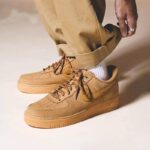 Nike Air Force 1 Low Wheat CJ9179-200 worn with khaki pants, demonstrating versatile streetwear and casual styling.