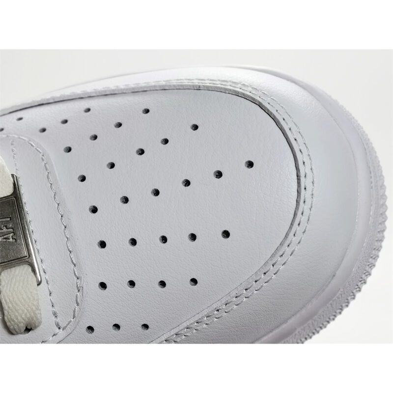 Close-up of Nike Air Force 1 Low White Black CJ0952-100 showing perforated white leather toe box, stitching detail, and AF1 lace tag.