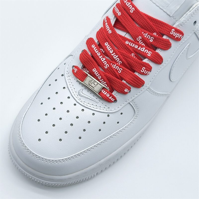 Close-up of Supreme x Nike Air Force 1 White red branded laces and metallic AF1 lace dubrae