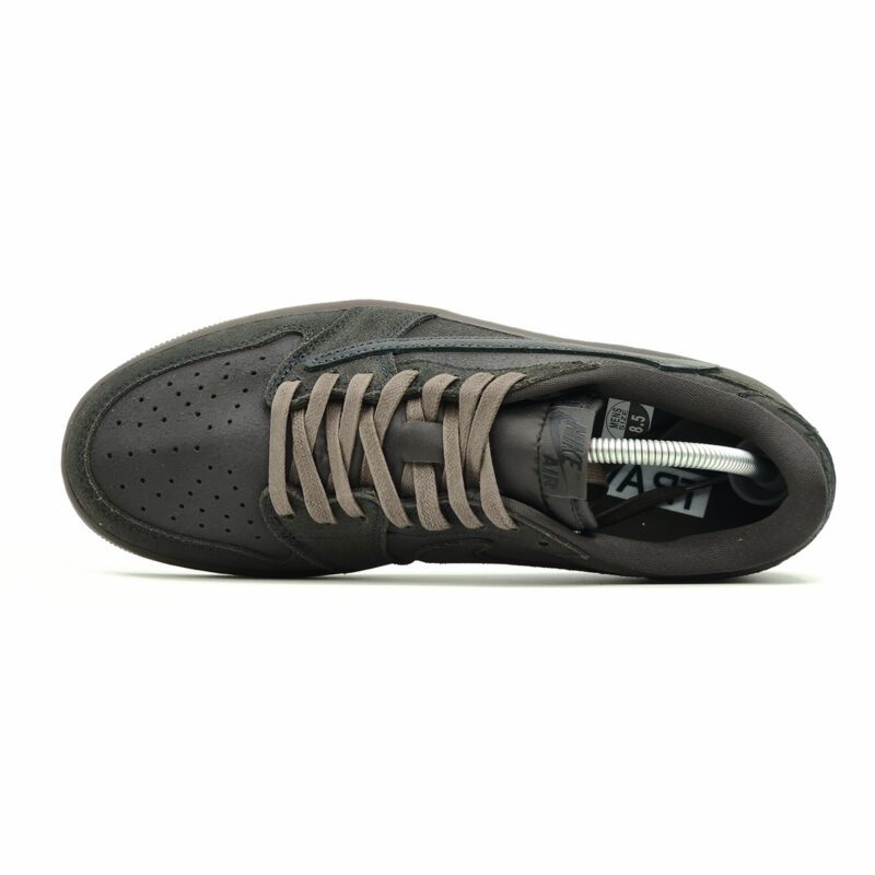 Top-down view of Travis Scott Air Jordan 1 Low Velvet Brown showing dark brown suede upper, matching laces, and Nike Air tongue branding.