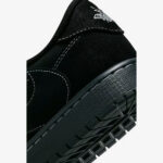 Close-up of the Travis Scott Jordan 1 Low Black Phantom heel featuring premium black suede, embroidered Wings logo, and textured rubber midsole.