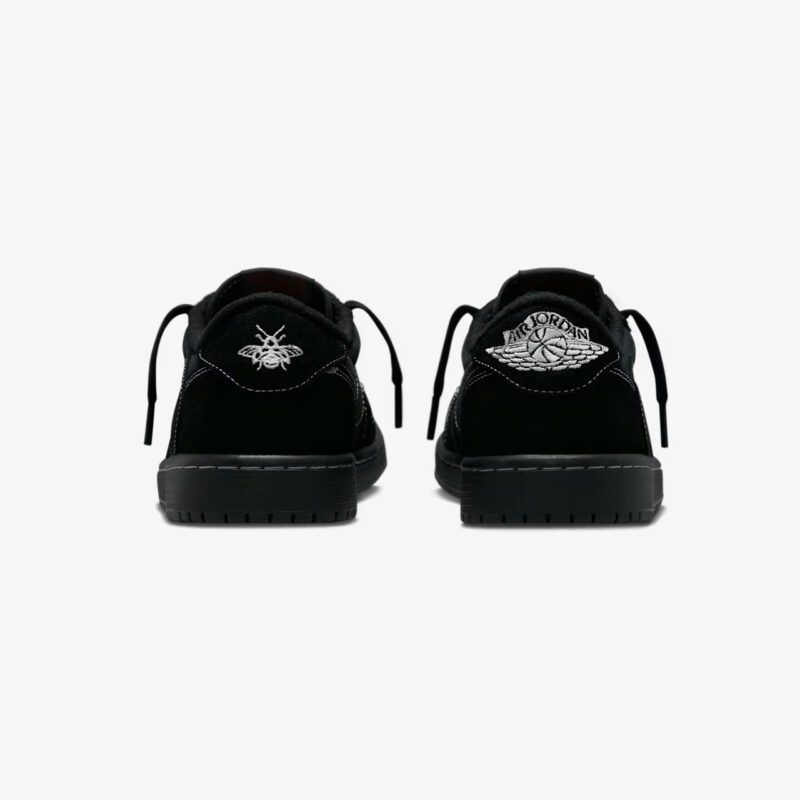 Rear heel view of the Travis Scott Jordan 1 Low Black Phantom displaying the Air Jordan Wings logo and Travis Scott bee embroidery.