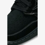Close-up of the Travis Scott Jordan 1 Low Black Phantom toe box showing premium nubuck leather, perforations, suede overlays, and white contrast stitching.
