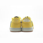 Rear view of Travis Scott Jordan 1 Low Canary featuring Air Jordan Wings logo and Cactus Jack embroidery.