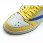 Close-up of Travis Scott Jordan 1 Low Canary perforated white leather toe box and yellow overlays.