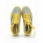 Top view of Travis Scott Jordan 1 Low Canary showing yellow laces, perforated toe box, and premium leather construction.