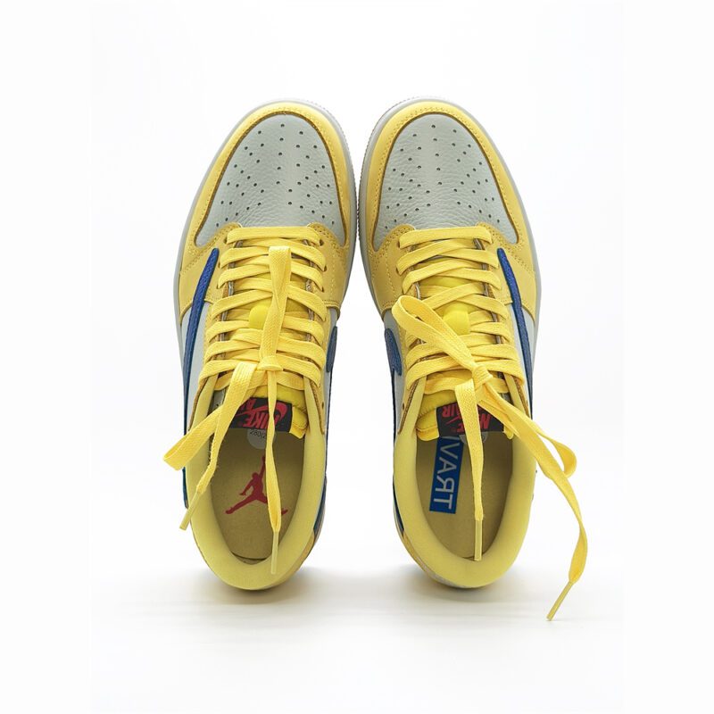 Top view of Travis Scott Jordan 1 Low Canary showing yellow laces, perforated toe box, and premium leather construction.