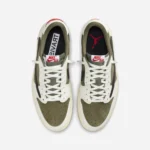 Top view of Travis Scott Air Jordan 1 Low Medium Olive showing premium suede toe box, Nike Air tongue labels, and classic lace setup.