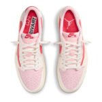 Top view of Travis Scott x Air Jordan 1 Low OG Tropical Pink showing tongue labels, lace setup, and premium leather upper.