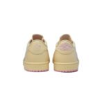 Rear heel view of the Travis Scott Air Jordan 1 Low Shy Pink displaying the Air Jordan Wings logo and Travis Scott face embroidery.