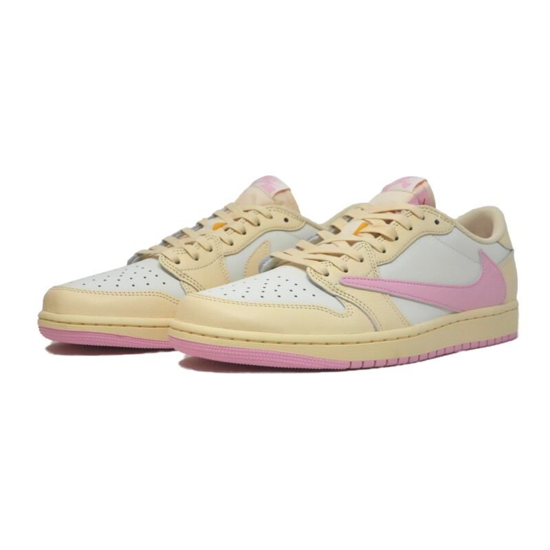 Travis Scott Air Jordan 1 Low Shy Pink sneakers displayed in a front three-quarter view featuring premium cream leather, pink reverse Swoosh, and pastel pink outsole.
